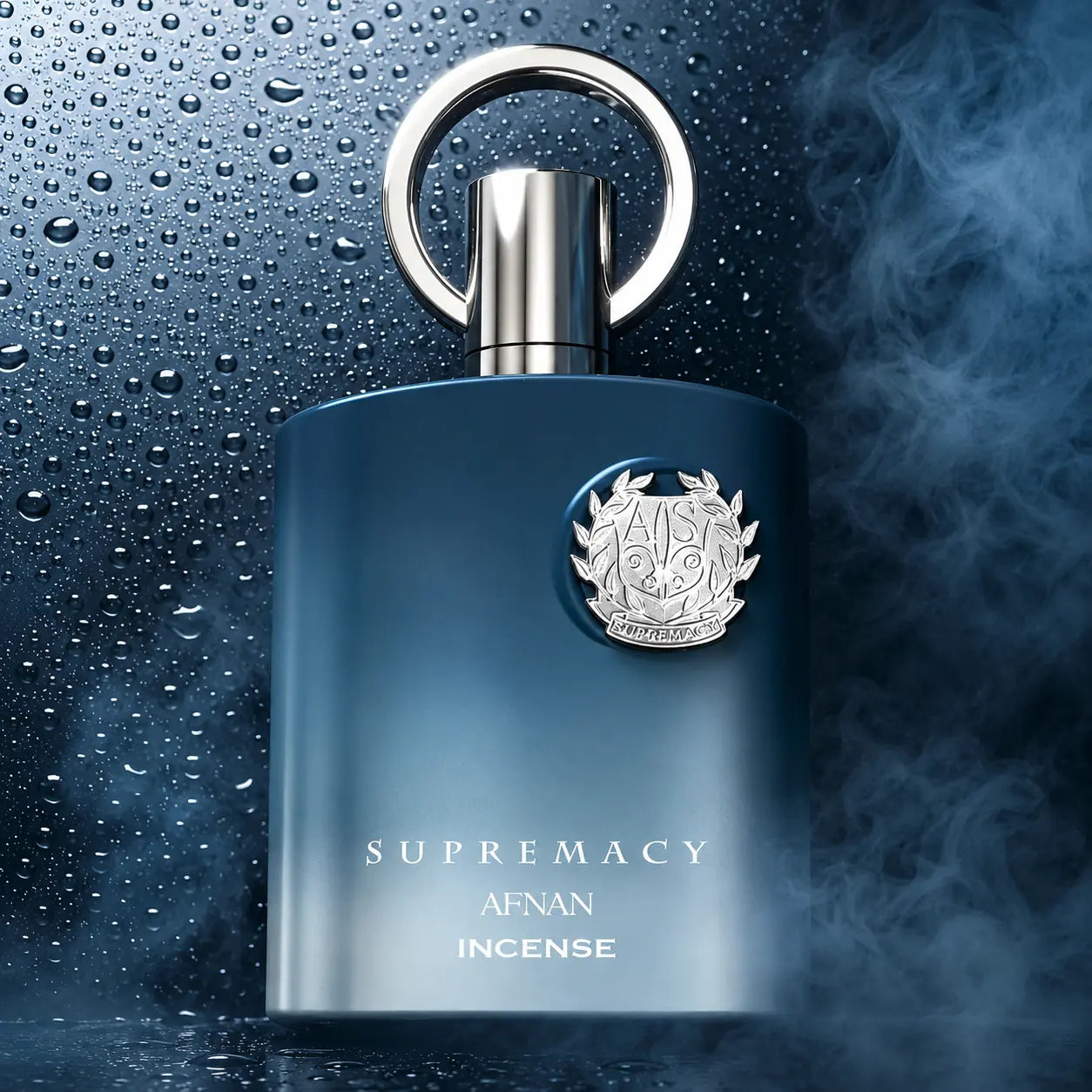 Afnan Supremacy Incense Eau De Parfum 100ml Luxury Perfume Bottle with a metallic silver cap and keyhole loop, set against a dark blue background with water droplets and mist.